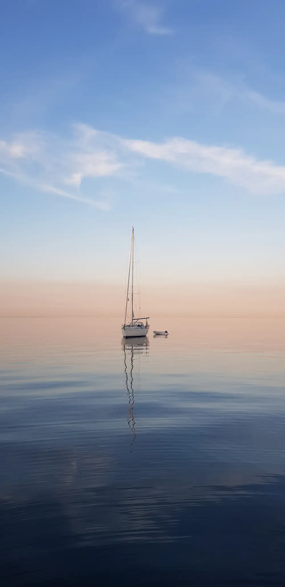 A sailboat at sea during sunset